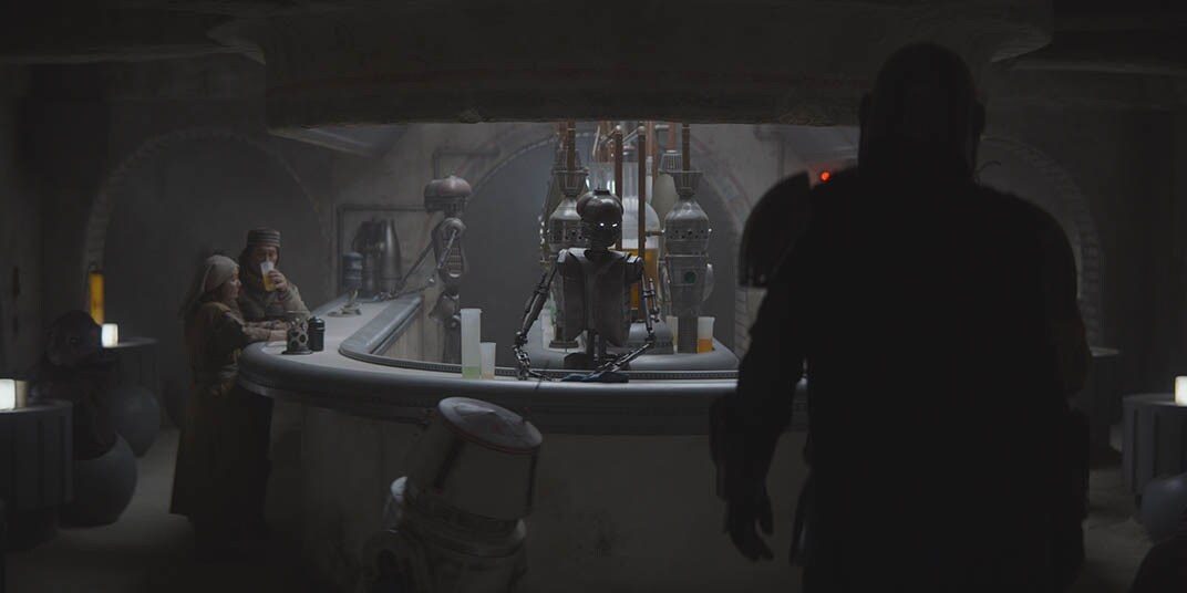 A dim cantina bar with droids behind it